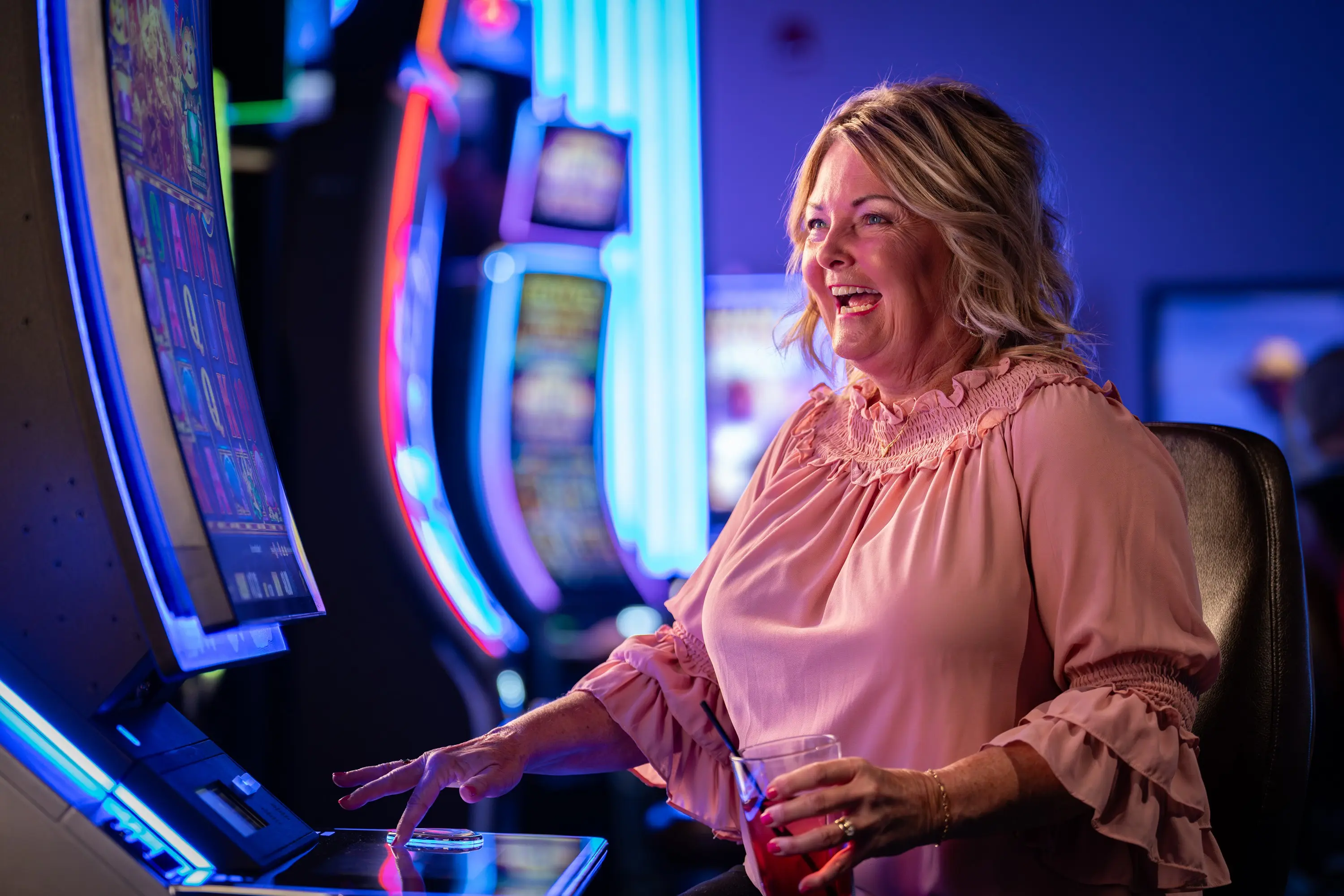 Woman playing slot machine at the Q Casino
